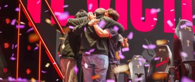 Maryville League of Legends team embraces in a victory hug celebrating a win.