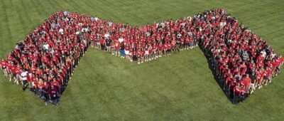 On-campus students at Maryville University stand in Big Red M formation