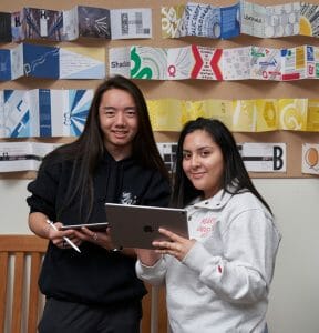 Two Maryville design students holding iPads